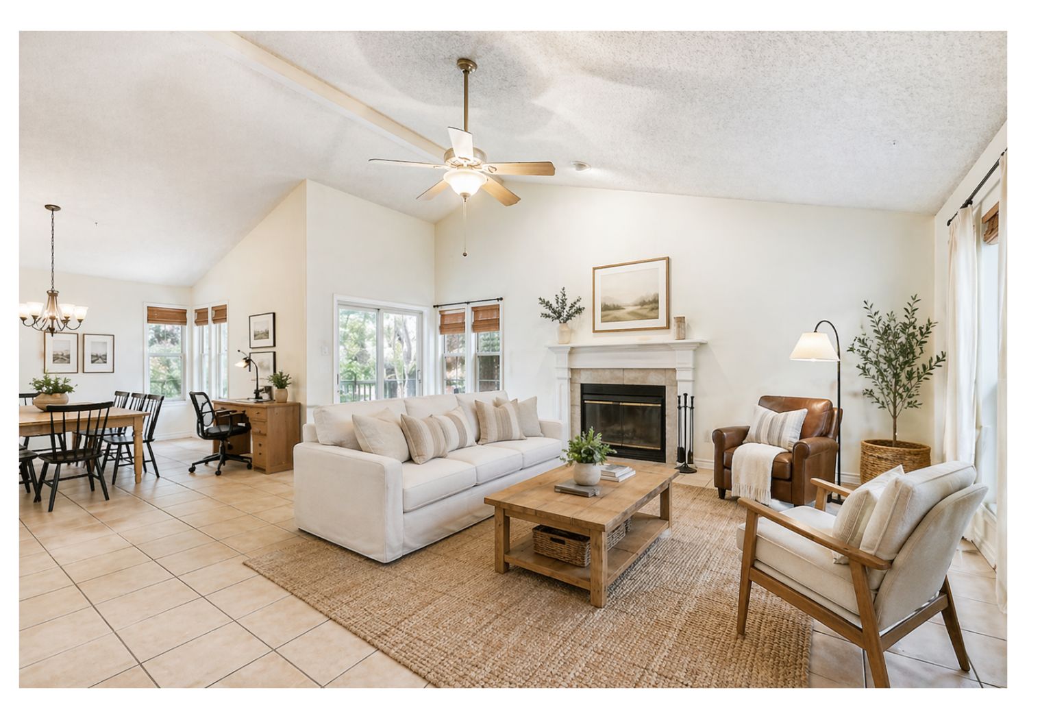 13129 New Boston Bend Austin, TX 78729 - Photo 4 of 26 Vaulted ceiling living area (Virtual Photo) featuring a fireplace with mantle, ceiling fan, and tile flooring