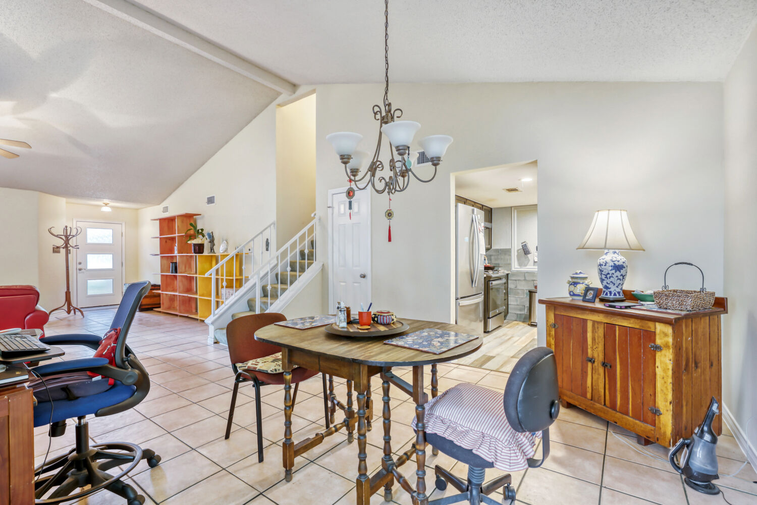 13129 New Boston Bend Austin, TX 78729 - Photo 8 of 26 Dining area featuring light tile patterned floors, a chandelier, a textured ceiling, and ceiling fan