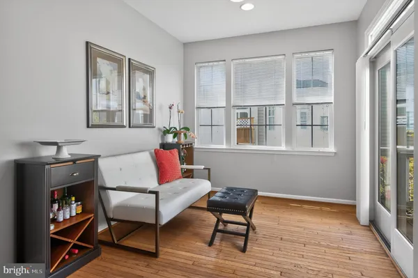 a living room with furniture a flat screen tv and a bookshelf