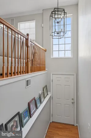 a kitchen with stainless steel appliances granite countertop white cabinets sink and window