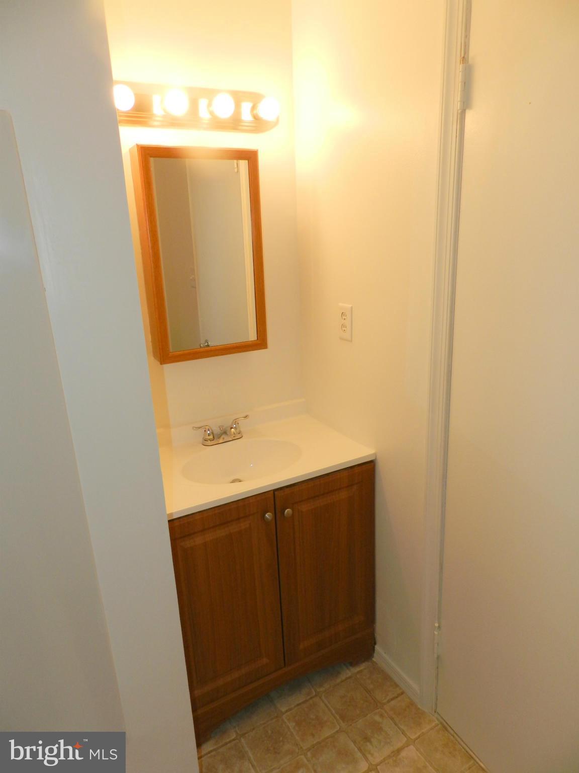 17435 Hughes Road Poolesville, MD 20837 - Photo 13 of 23 a bathroom with a sink and a mirror
