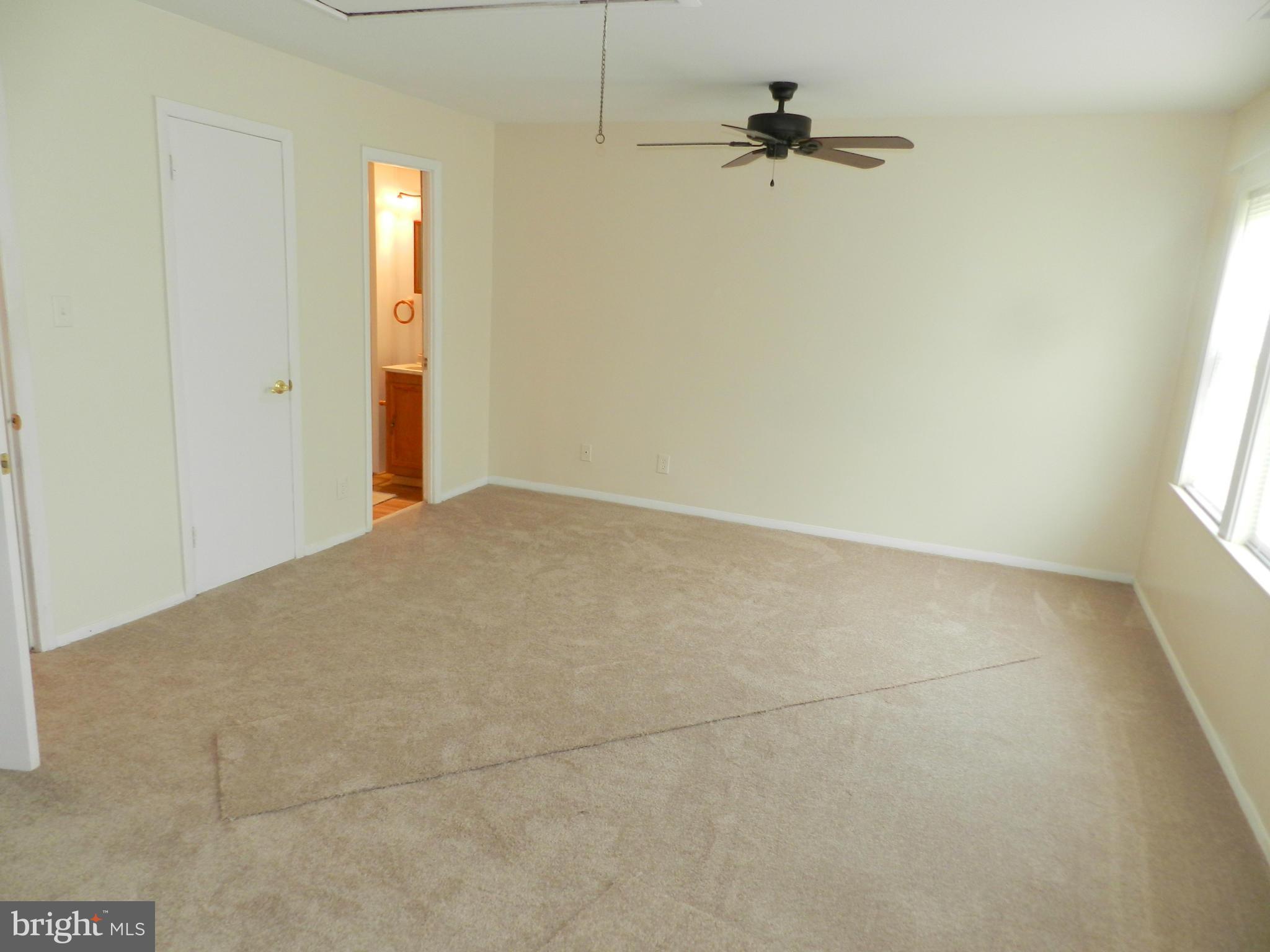 17435 Hughes Road Poolesville, MD 20837 - Photo 10 of 23 an empty room with windows and fan