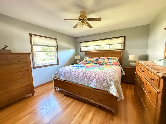 a bedroom with a bed and a flat tv screen on dresser