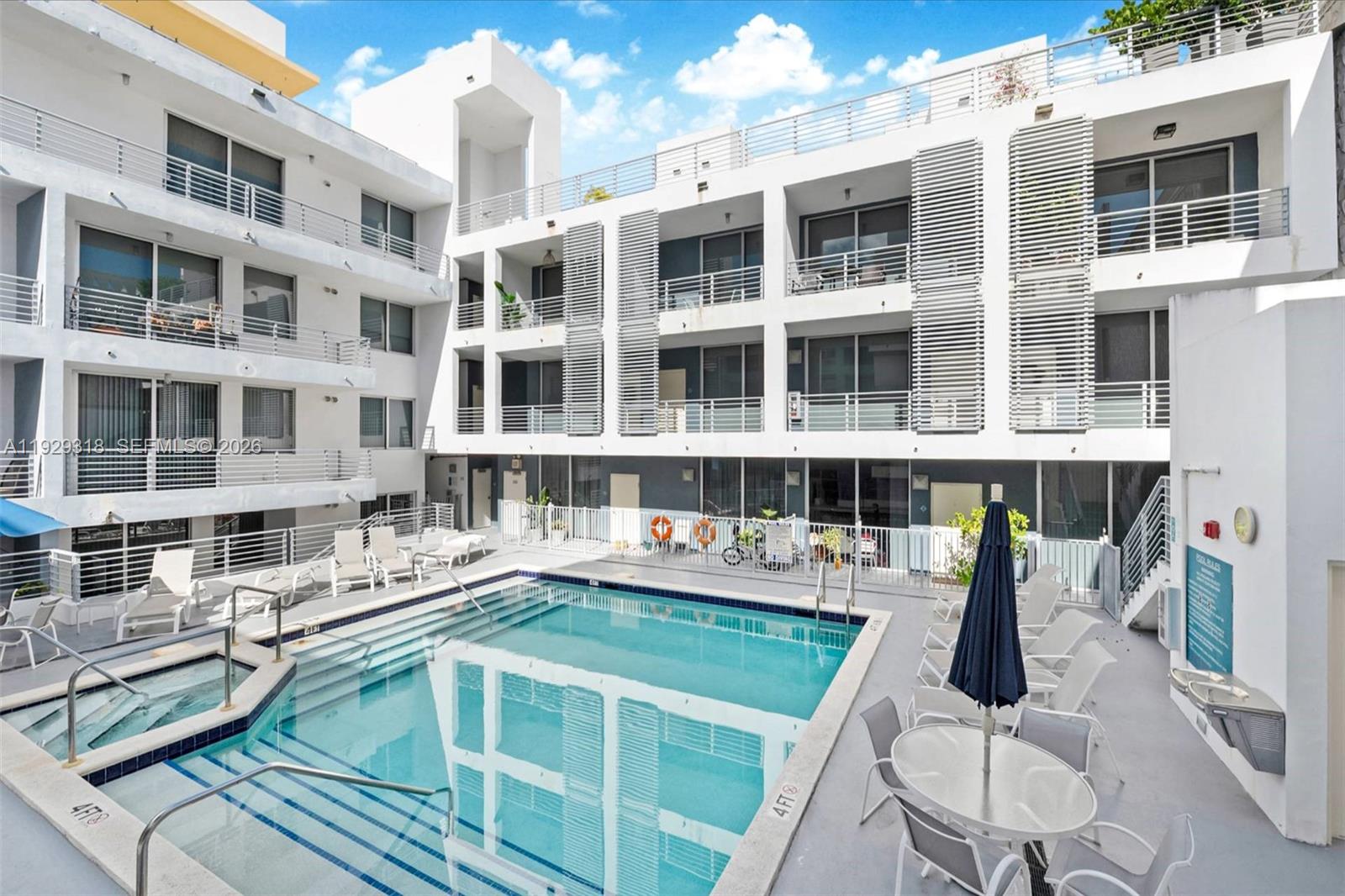 3339 Virginia Street, Unit 305 Miami, FL 33133 - Photo 14 of 17 a view of a building with a dining table chairs and barbeque grill