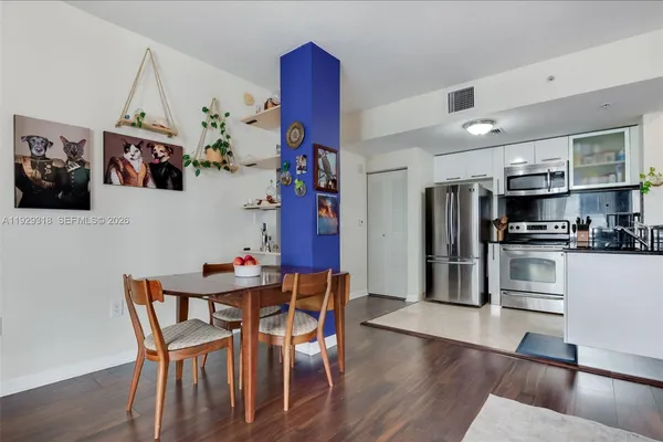 a view of a dining room with furniture and wooden floor