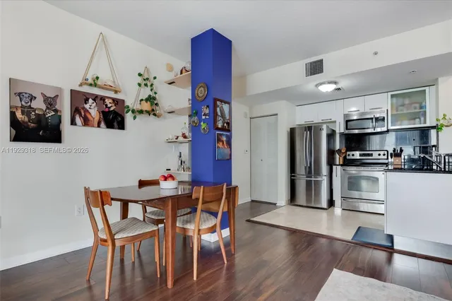 a view of a dining room with furniture and wooden floor