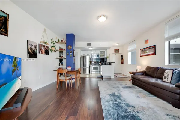 a living room with furniture and wooden floor
