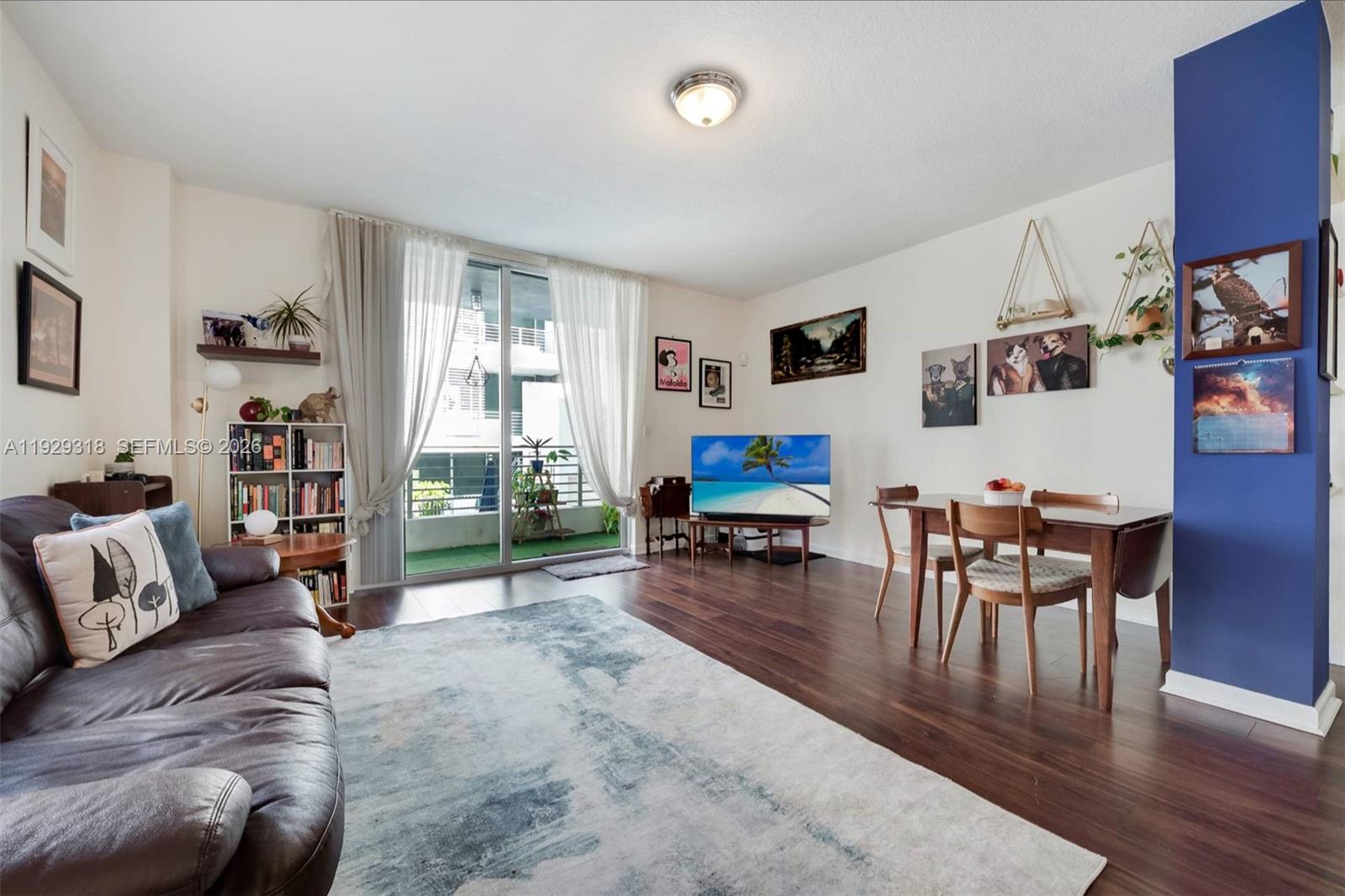 3339 Virginia Street, Unit 305 Miami, FL 33133 - Photo 6 of 17 a living room with furniture and a flat screen tv