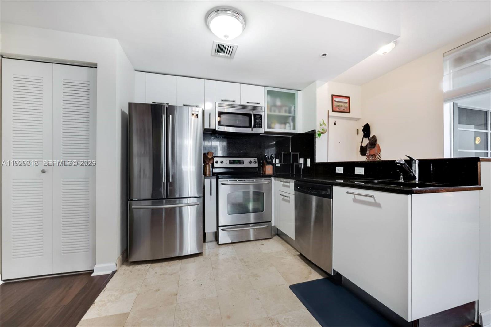 3339 Virginia Street, Unit 305 Miami, FL 33133 - Photo 7 of 17 a kitchen with stainless steel appliances a refrigerator and a stove