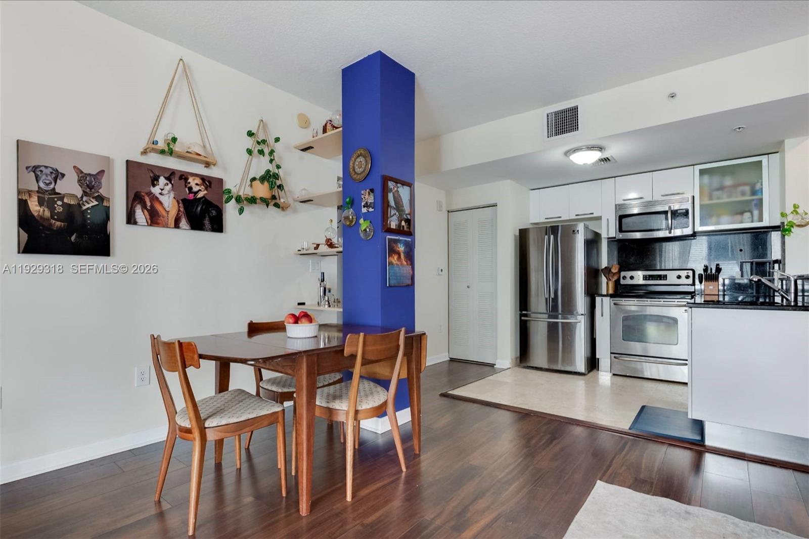 3339 Virginia Street, Unit 305 Miami, FL 33133 - Photo 8 of 17 a view of a dining room with furniture and wooden floor