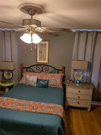 a bedroom with a bed and ceiling fan