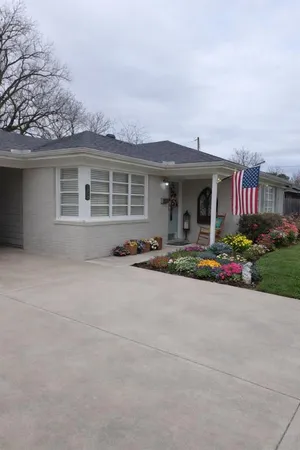 front view of house with yard and trees around