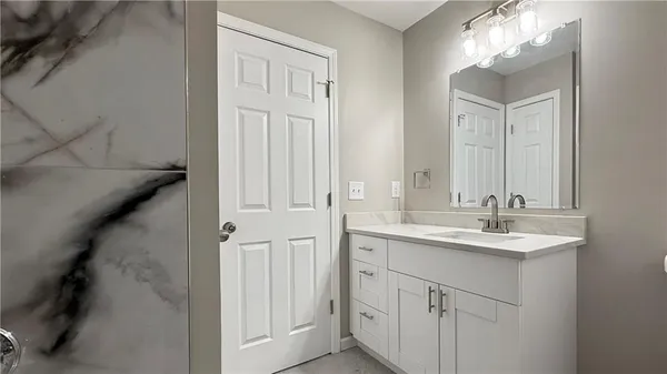 an empty room with closet and fan