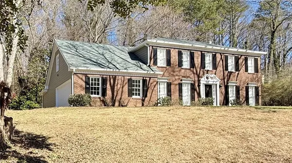 a view of a house with a large tree