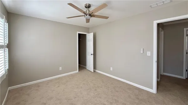 a view of walk in closet with window and small yard