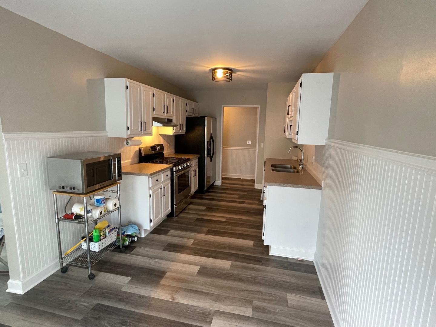 62 Fernwood Road Montgomery, IL 60538 - Photo 8 of 16 a kitchen view with wooden floor and cabinets