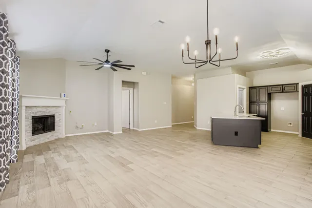 a view of an empty room with a fireplace
