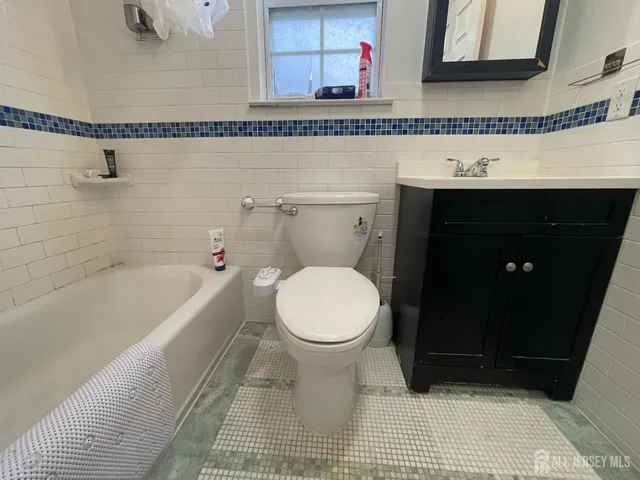 a bathroom with a granite countertop bathtub and a sink