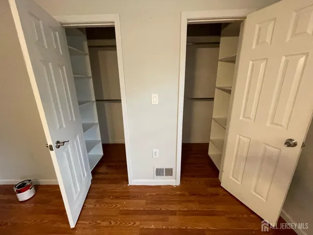 a view of a hallway with wooden floor and stairs