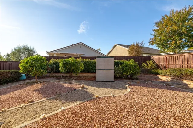 a living room with patio furniture and a floor to ceiling window