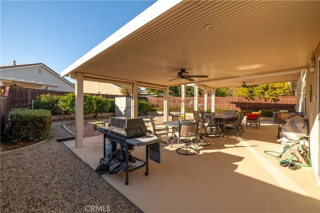 a view of a porch with furniture and floor to ceiling window