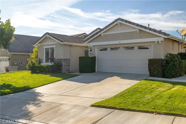 an aerial view of a house with a yard and lake view