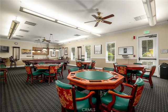 a view of a swimming pool with a yard and sitting area