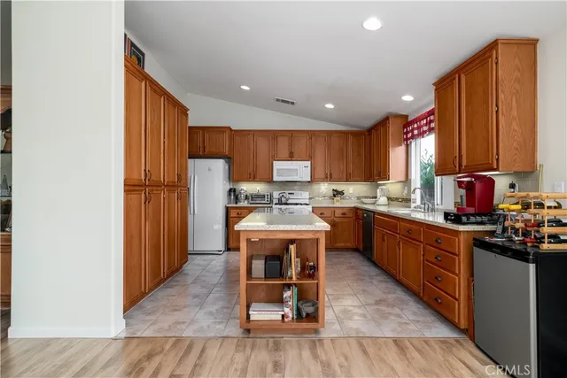 a view of a dining room and livingroom with furniture wooden floor a chandelier