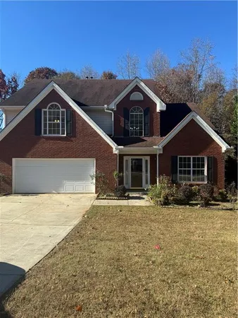 a front view of a house with a yard