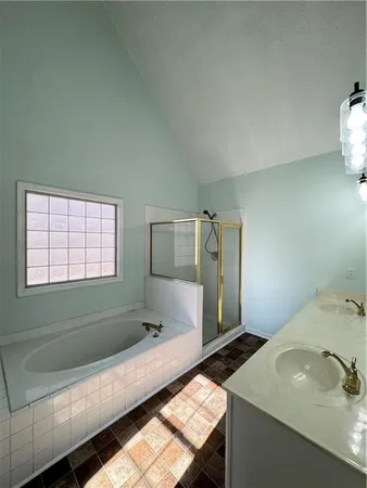 a bathroom with a tub sink and mirror