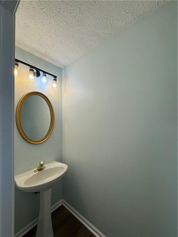 1009 Chads Ridge Jonesboro, GA 30236 - Photo 5 of 28 a bathroom with a sink a mirror and a toilet