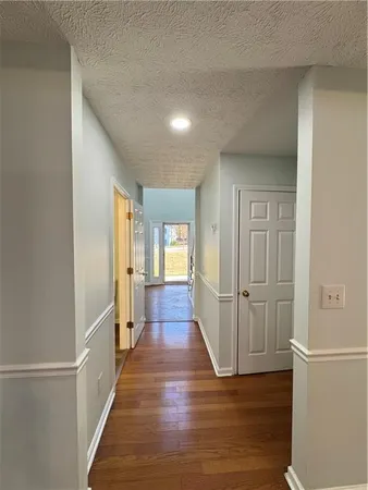 a view of a hallway with wooden floor