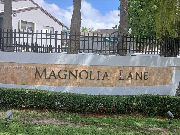 a street sign that is on a brick wall