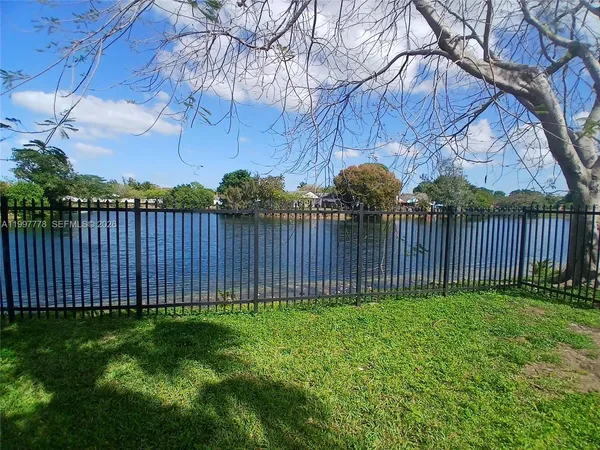 a view of a backyard with wooden fence
