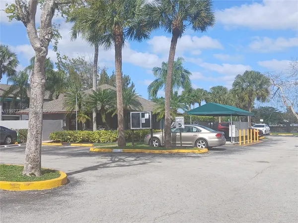 a view of a building with palm trees