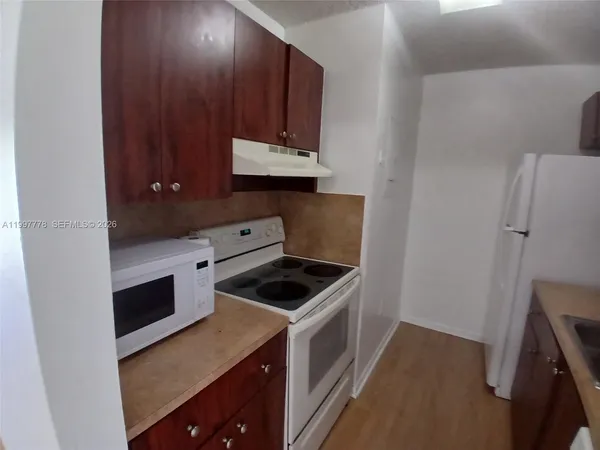 a kitchen with a stove and a microwave