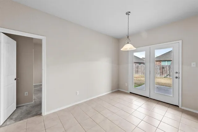 a view of an empty room with window and cabinet