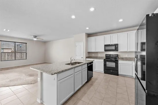 a kitchen with a stove a sink and a refrigerator