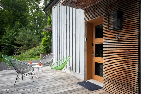 a view of a patio with a table and chairs next to a yard