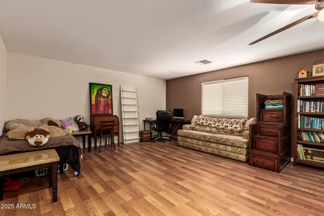 a living room with furniture and a bookshelf