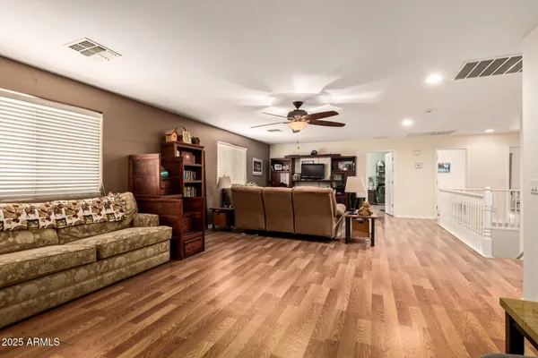a living room with furniture and a wooden floor