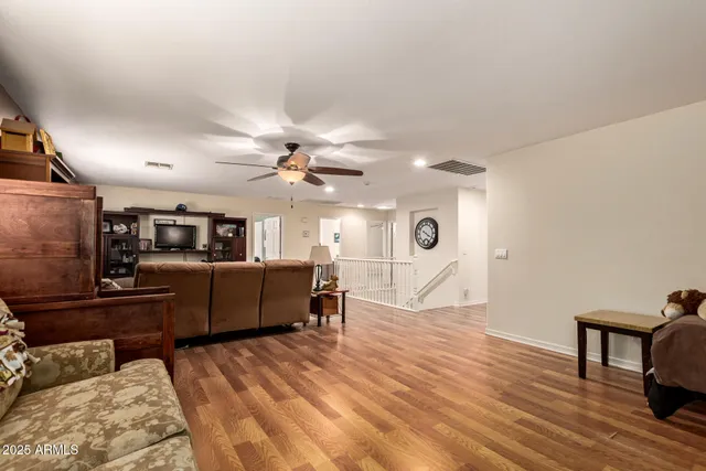a living room with furniture and a wooden floor