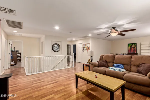 a living room with furniture and a wooden floor