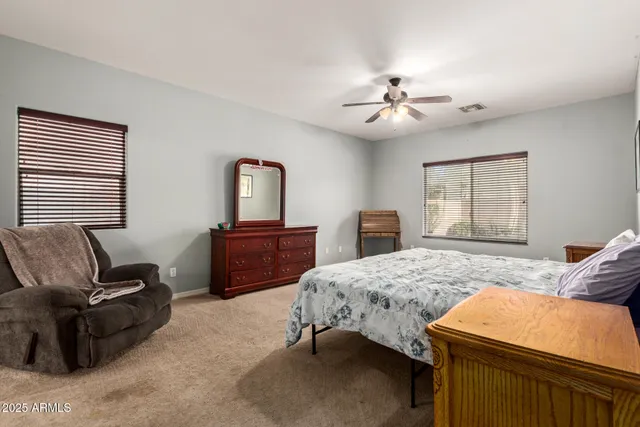a bedroom with a bed dresser and a window