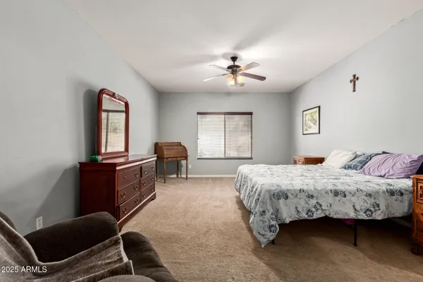 a bedroom with a bed chair and window