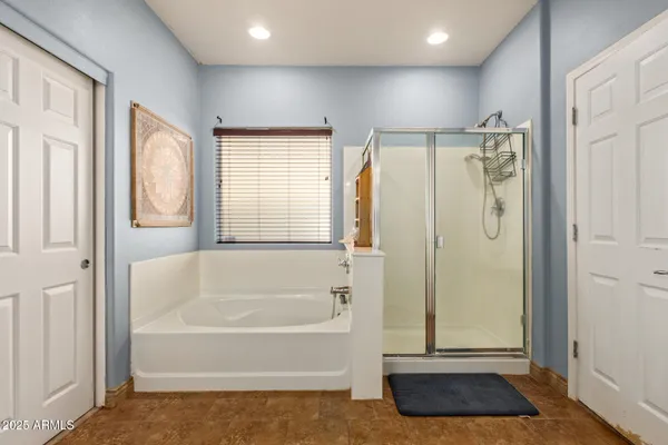a bathroom with a tub and a shower