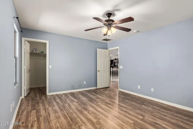 a view of empty room with wooden floor