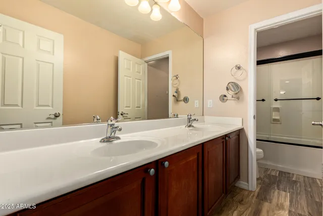 a bathroom with a double vanity sink mirror and double