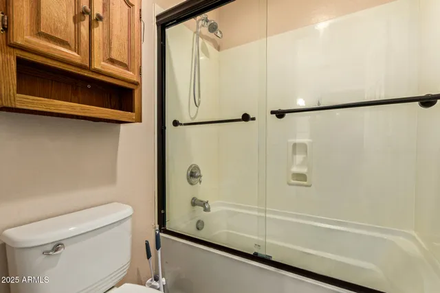 a bathroom with a shower and a toilet