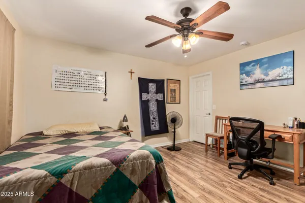 a bedroom that has a bed and a chair in it